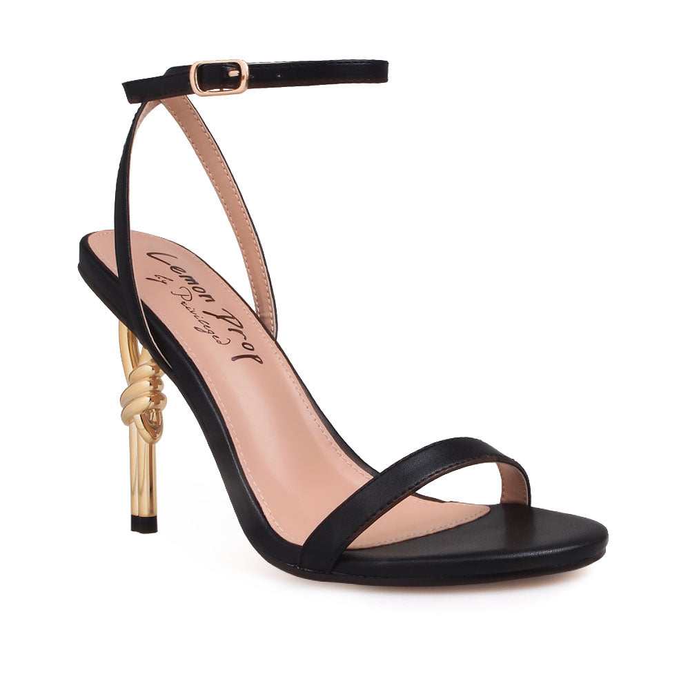 Black upper with ankle buckle closure and gold metallic heels - corner view