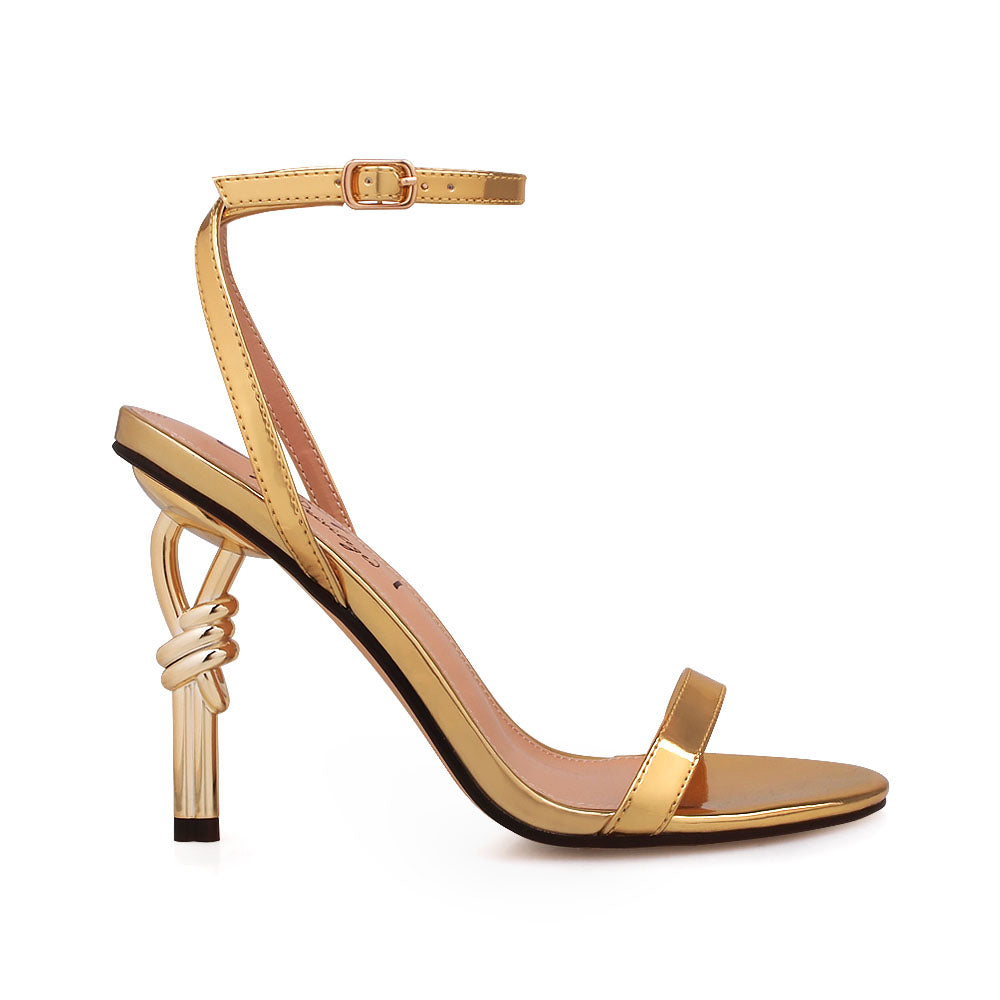 Golden metallic heels with ankle buckle closure and open toe design - side view