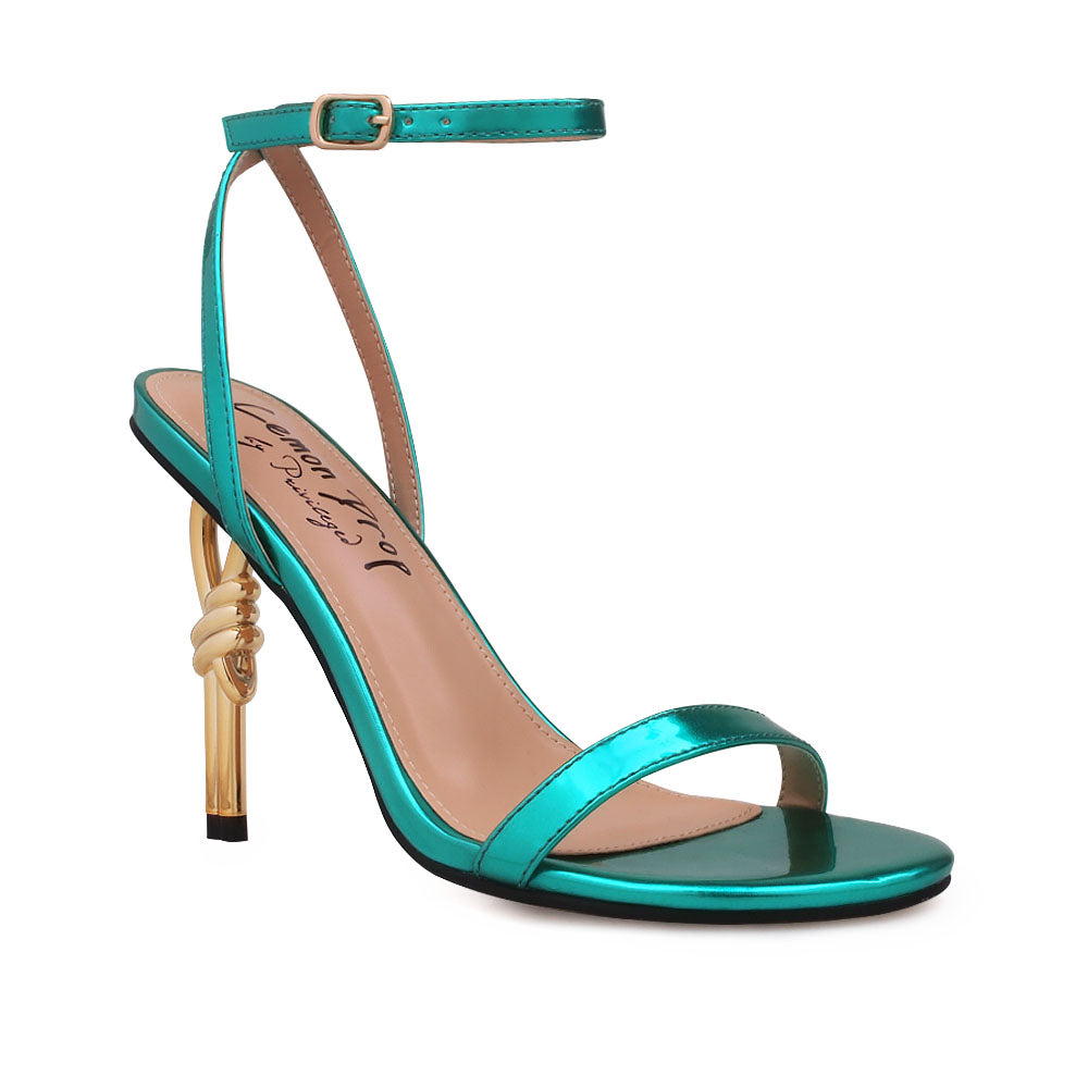 Gold colored metallic heels with teal upper and ankle buckle closure - corner view