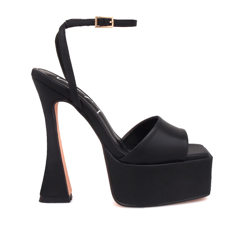 Black platform heels with open toe and ankle buckle closure - side view