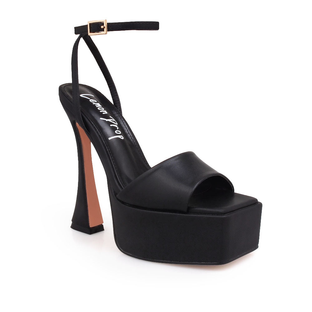 Black platform heels with open toe and ankle buckle closure - corner view