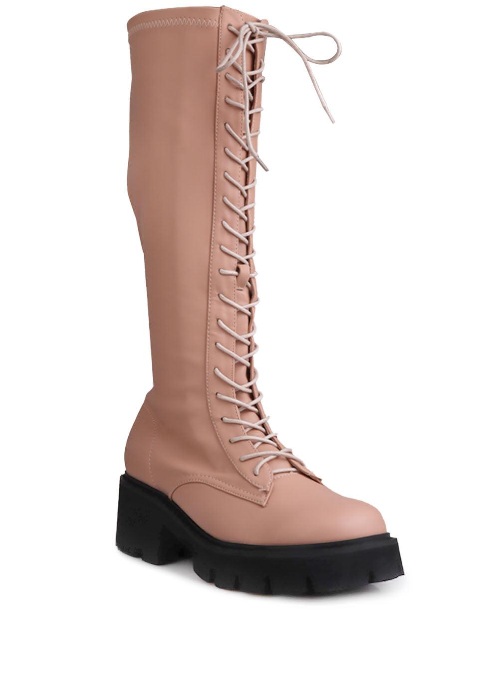 Women's nude-colored knee high boots with a lace up closure-corner view