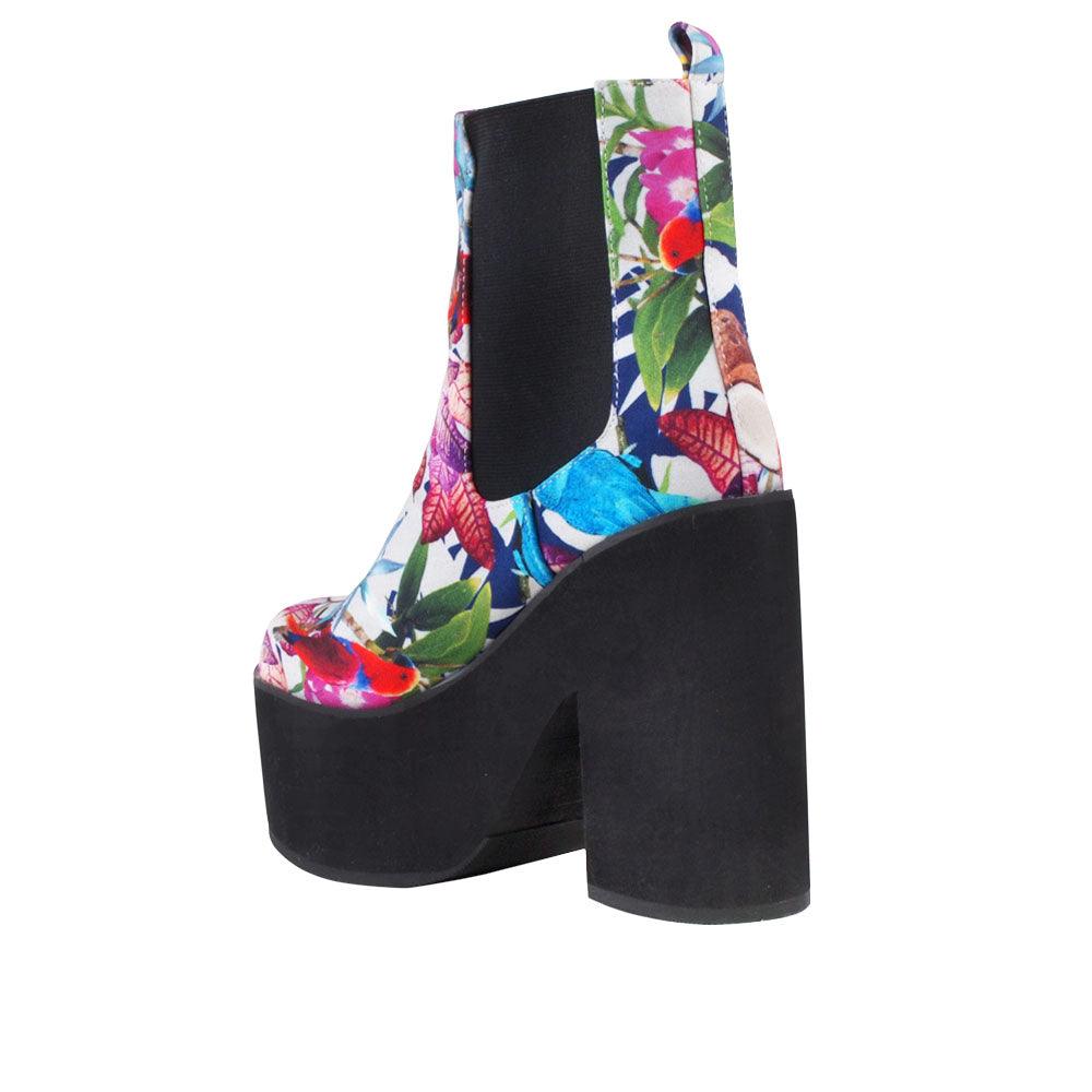 Women's black-colored block heel ankle boots with a floral-multicolored pattern on the upper and slip-on style-posterior view