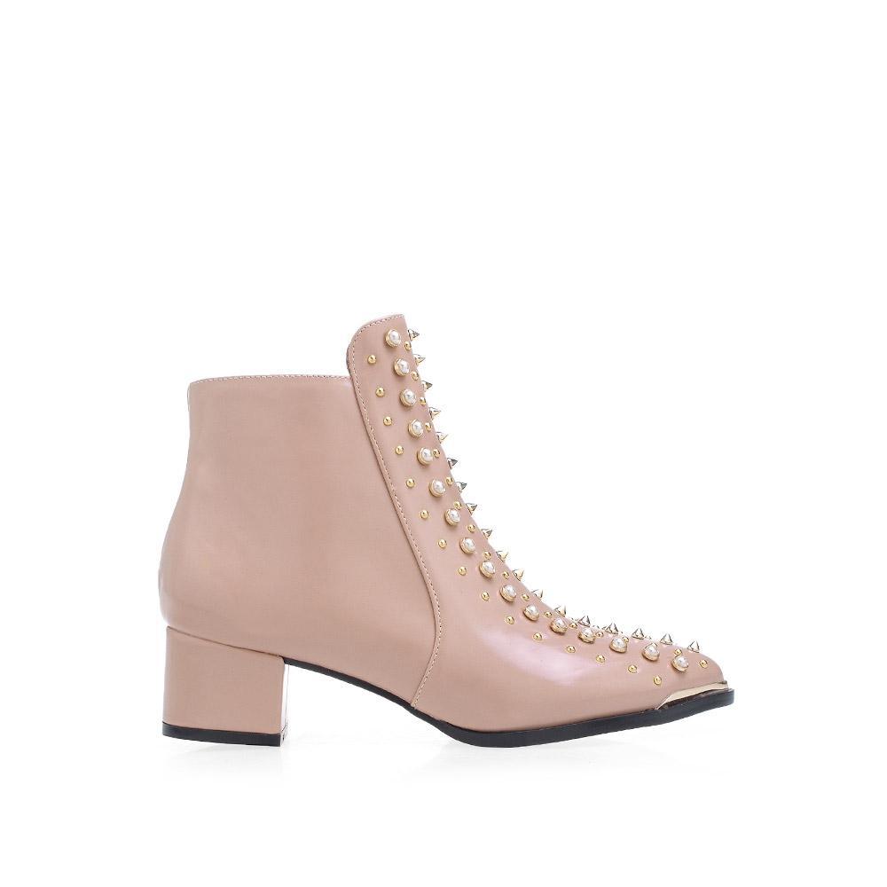 Women's ankle boots in blush-color with block heels and metallic gold spikes, studs, and pearl accents.