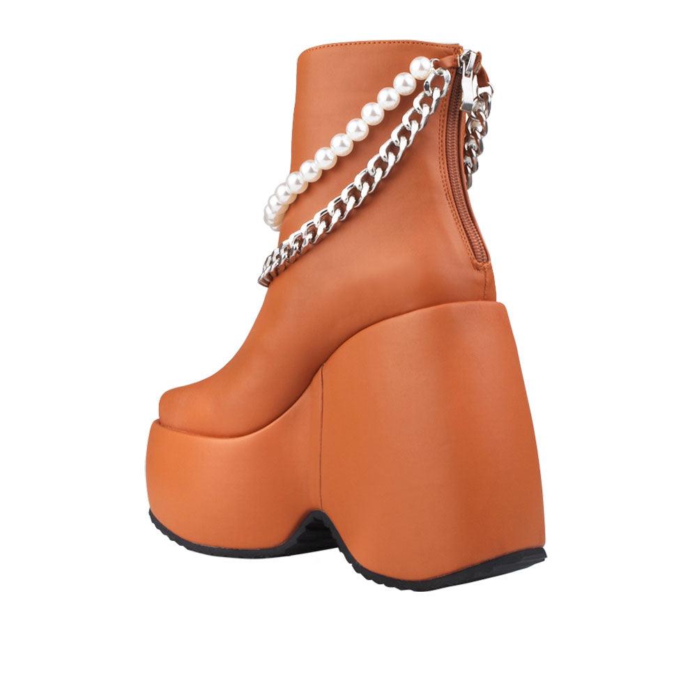 Brown colored women bootie platforms with pearl and silver embellished strap-posterior view