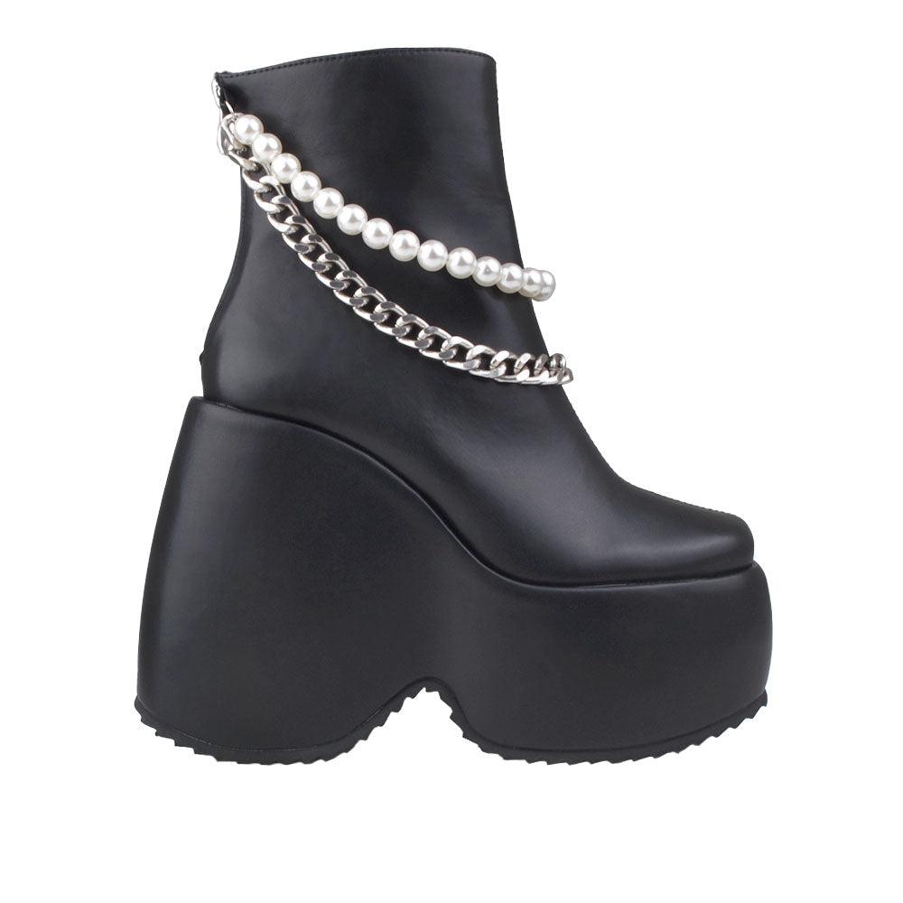 Black colored women bootie platforms with pearl and silver embellished strap-side view