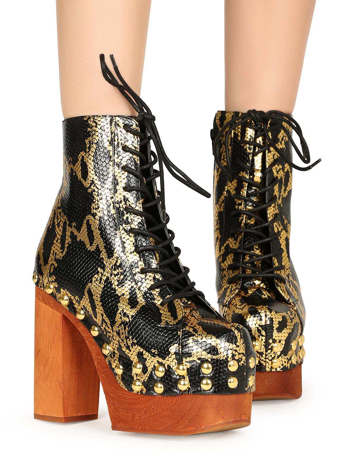 Black and gold snake textured women boots with brown heel