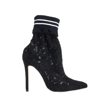 Black shiny textured women booties with stilleto heel and cargo fitted top