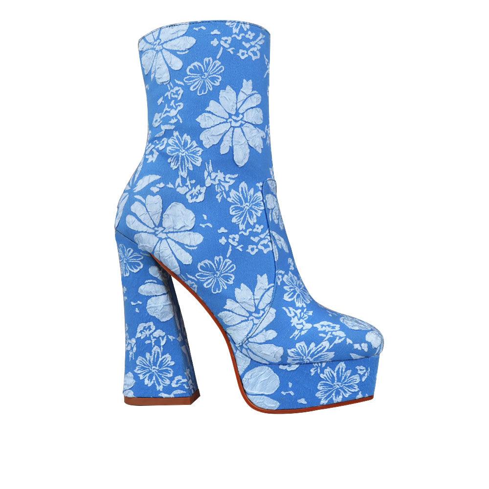 Blue platform ankle high boot heels with floral print and side zipper fastening.