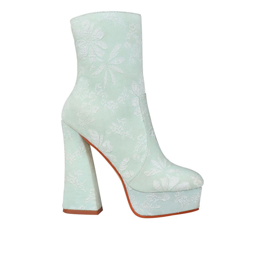 Mint colored platform ankle boot heels with floral print and side zip clasp.