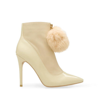 Beige colored ankle high boots with pointed toe and front zipper closure with fur top