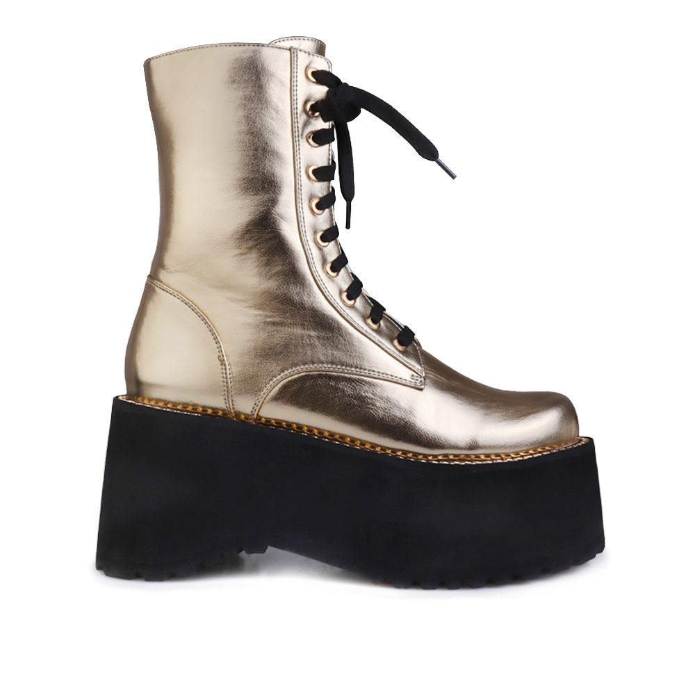 Black colored platform boots with golden upper, lace up design and side zipper clasp