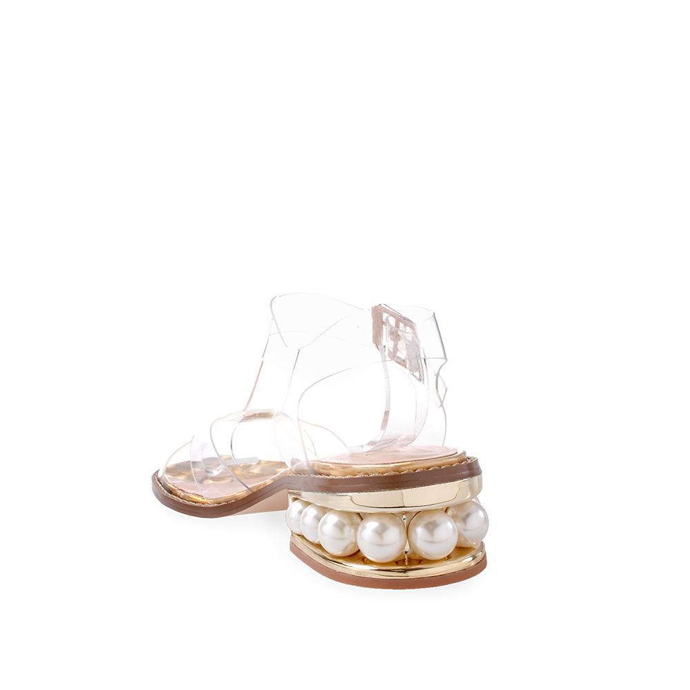 golden-colored women's flat shoes with clear straps and buckle-posterior view