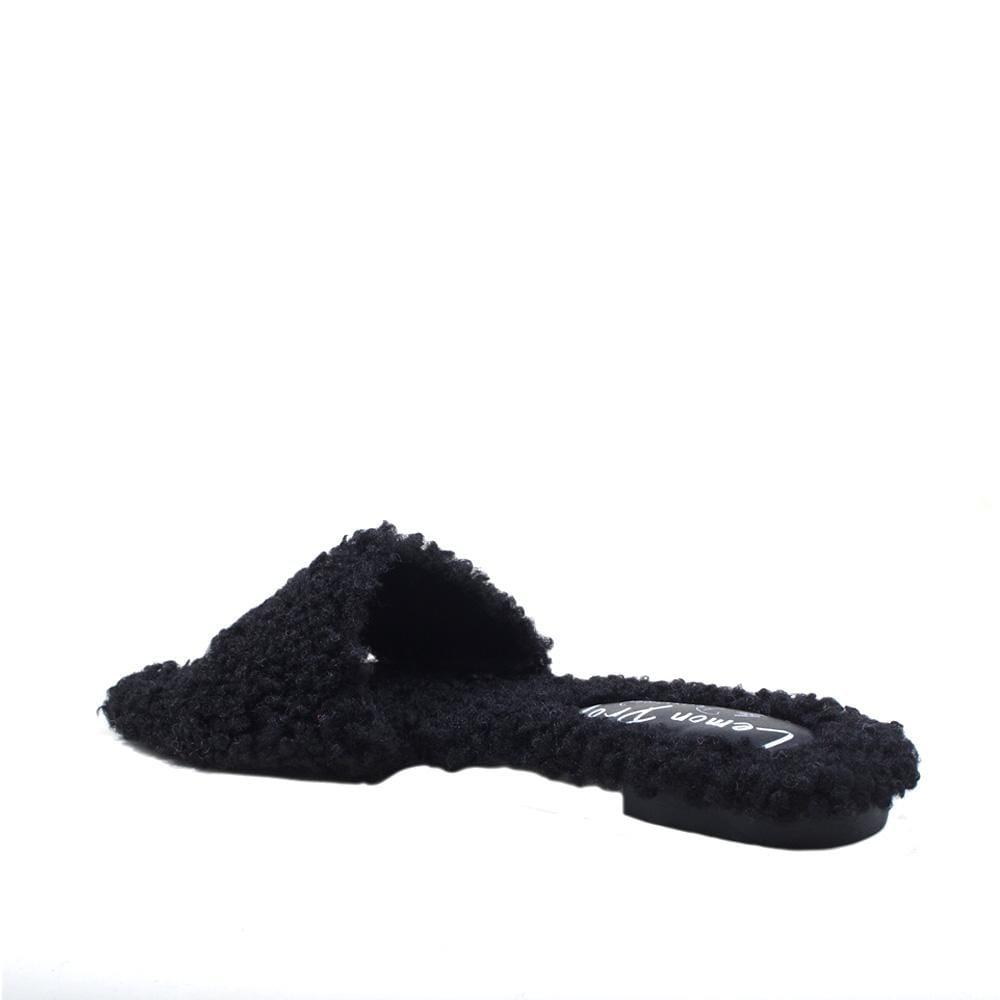 Black colored women's flats with shearling upper-psoterior view