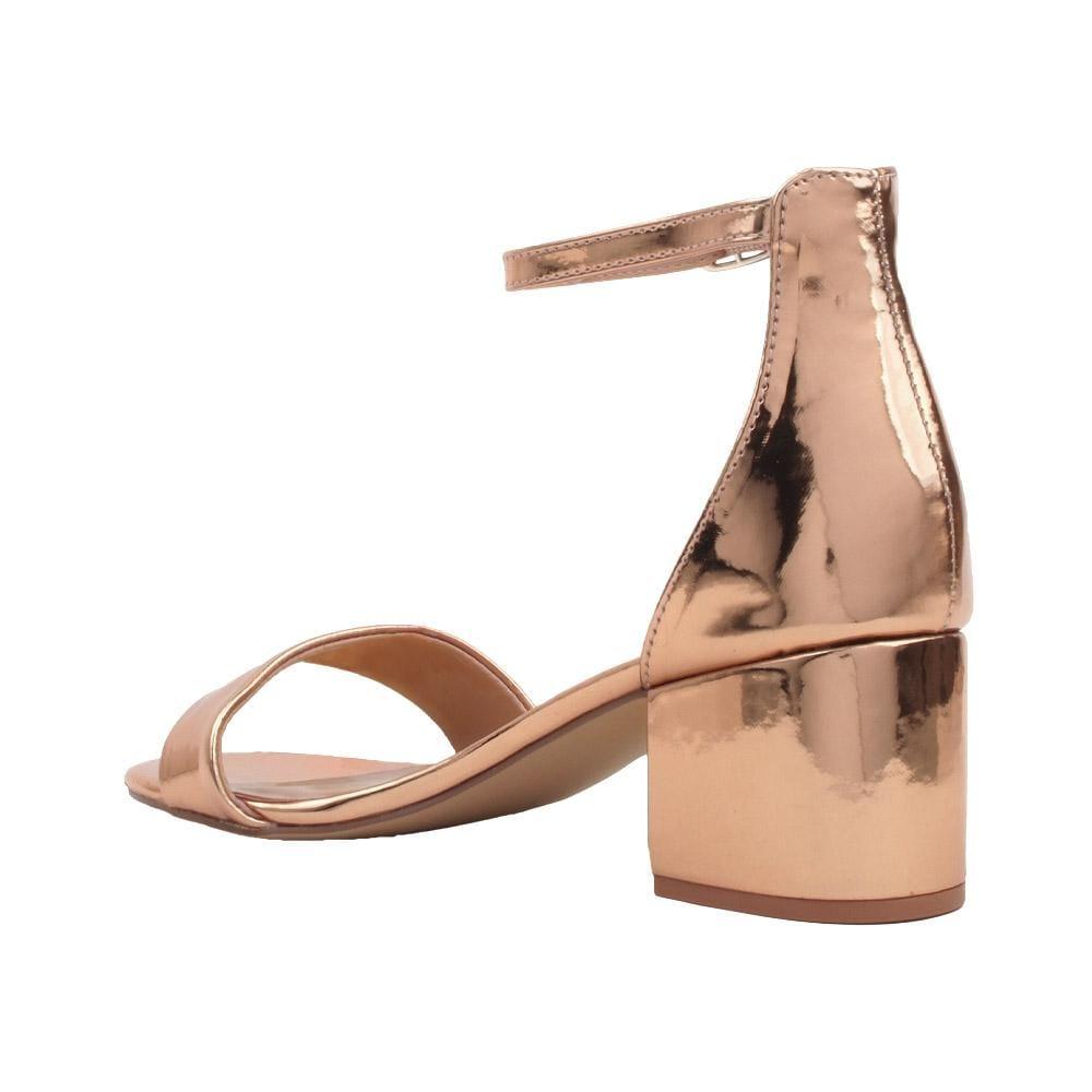 Flat rose gold heels with an open toe and ankle buckle closure-posterior view