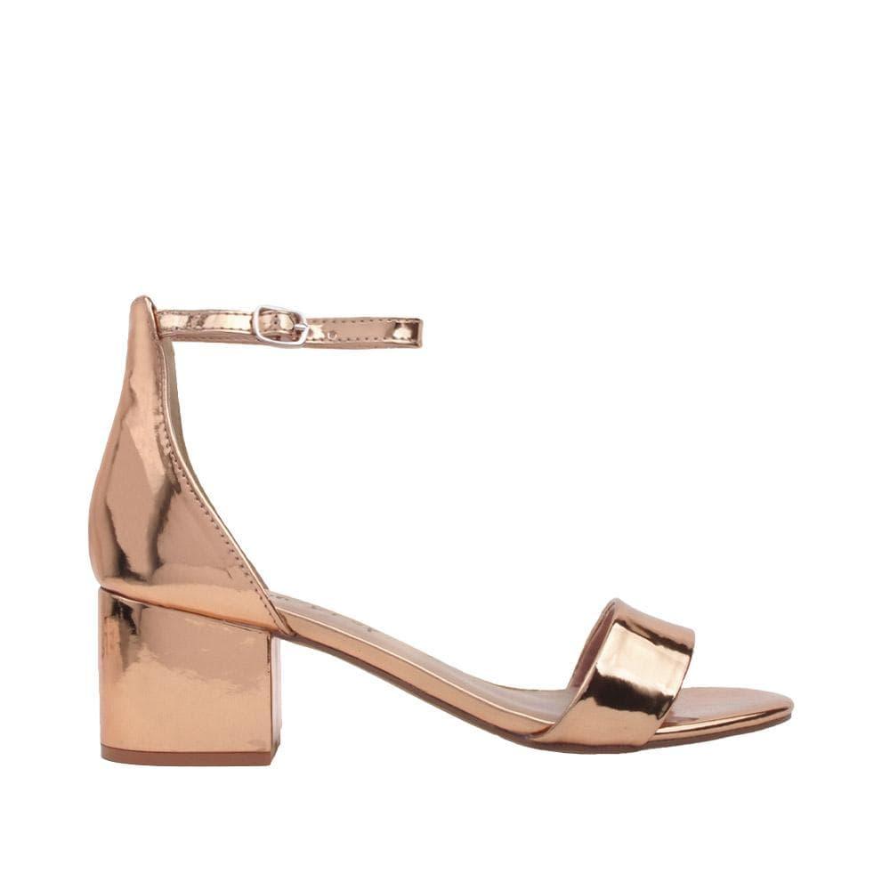 Flat rose gold heels with an open toe and ankle buckle closure-side view