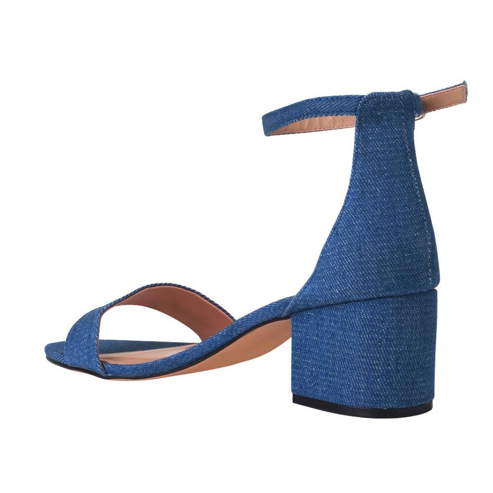 Heel flats in denim-color with a buckle ankle closure and a strapped open toe-posterior view