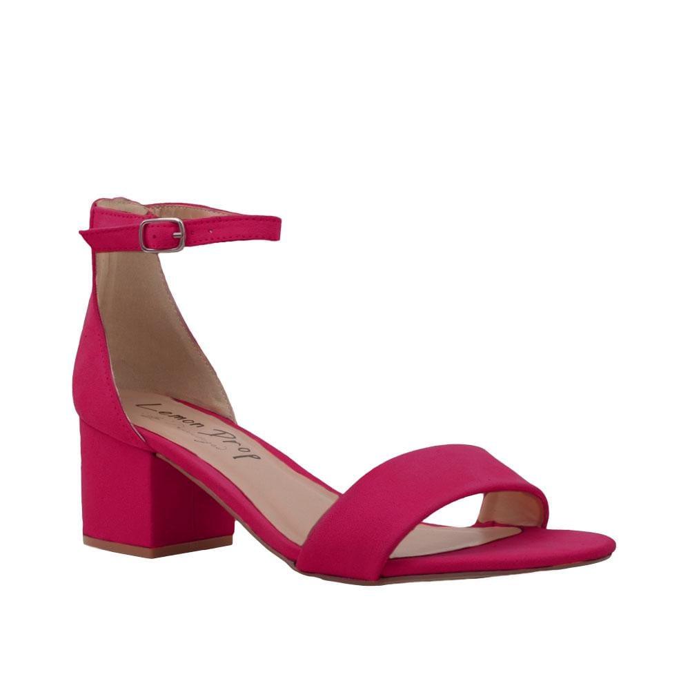 Fuchsia-colored heel flats with a buckle ankle closure and a strapped open toe-corner view