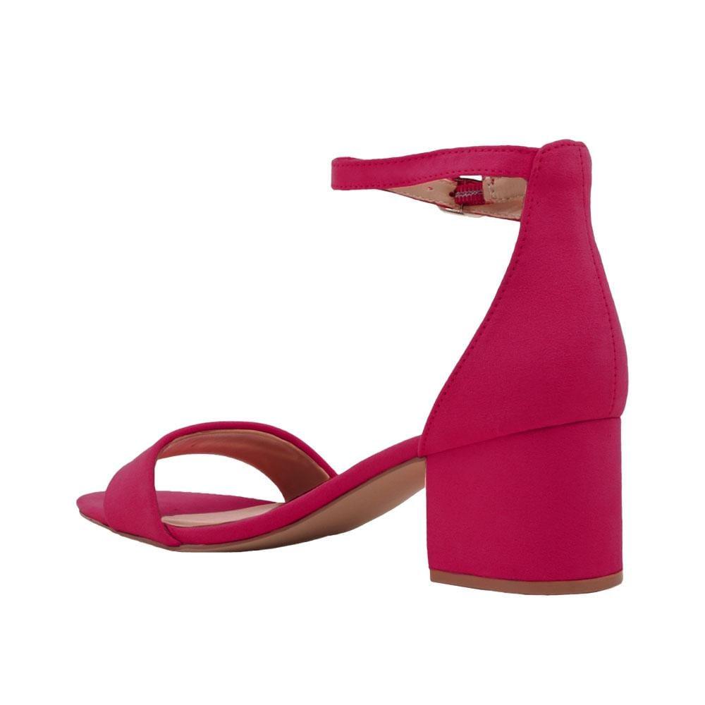 Fuchsia-colored heel flats with a buckle ankle closure and a strapped open toe-posterior view