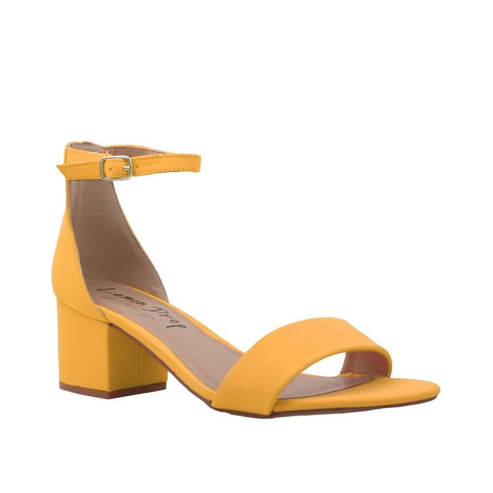 Yellow-colored heel flats with a buckle ankle clasp and strapped open toe-corner view