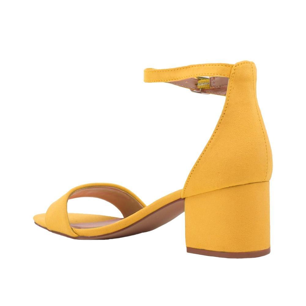 Yellow-colored heel flats with a buckle ankle clasp and strapped open toe-posterior view