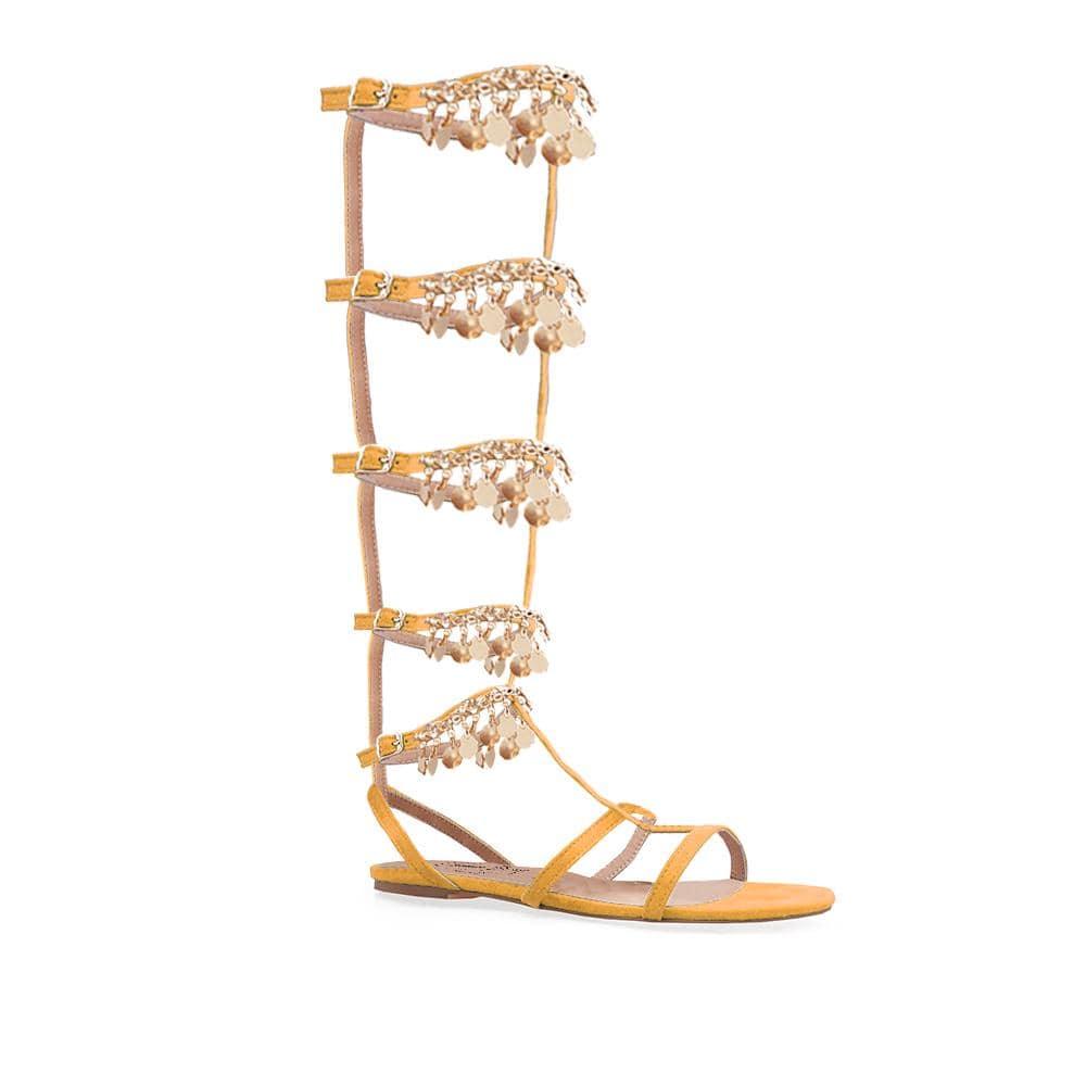 Knee high women's sandals with gold metallic chain and rhinestone accents in cognac-corner view