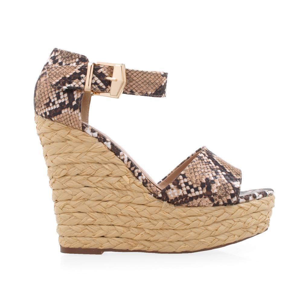 Platform shoes with ankle buckle clasp and tan-black snake pattern on the upper.