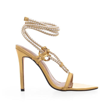 Women's golden colored heels with lace tie closure