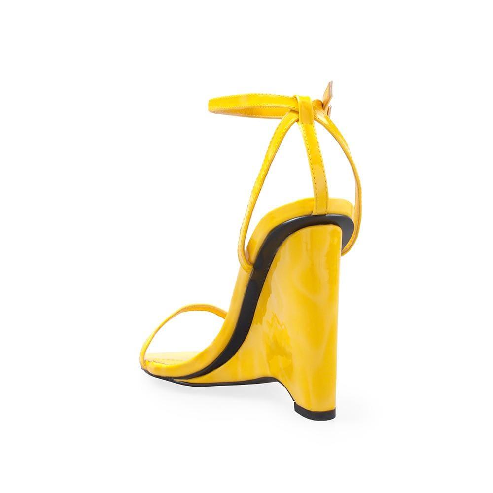 Vegan patent leather women's wedge heel in yellow-posterior view