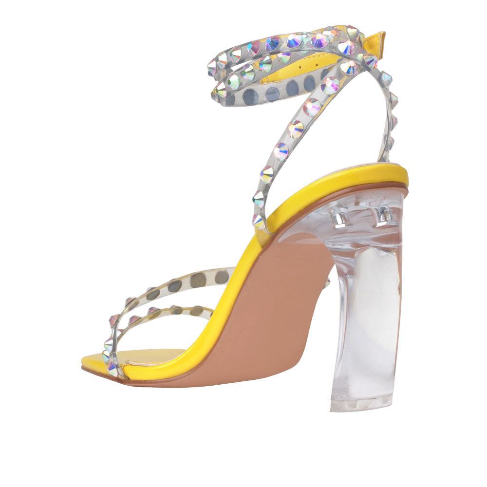 Ankle-strap heels in a bright yellow color with an open toe and buckle - posterior view