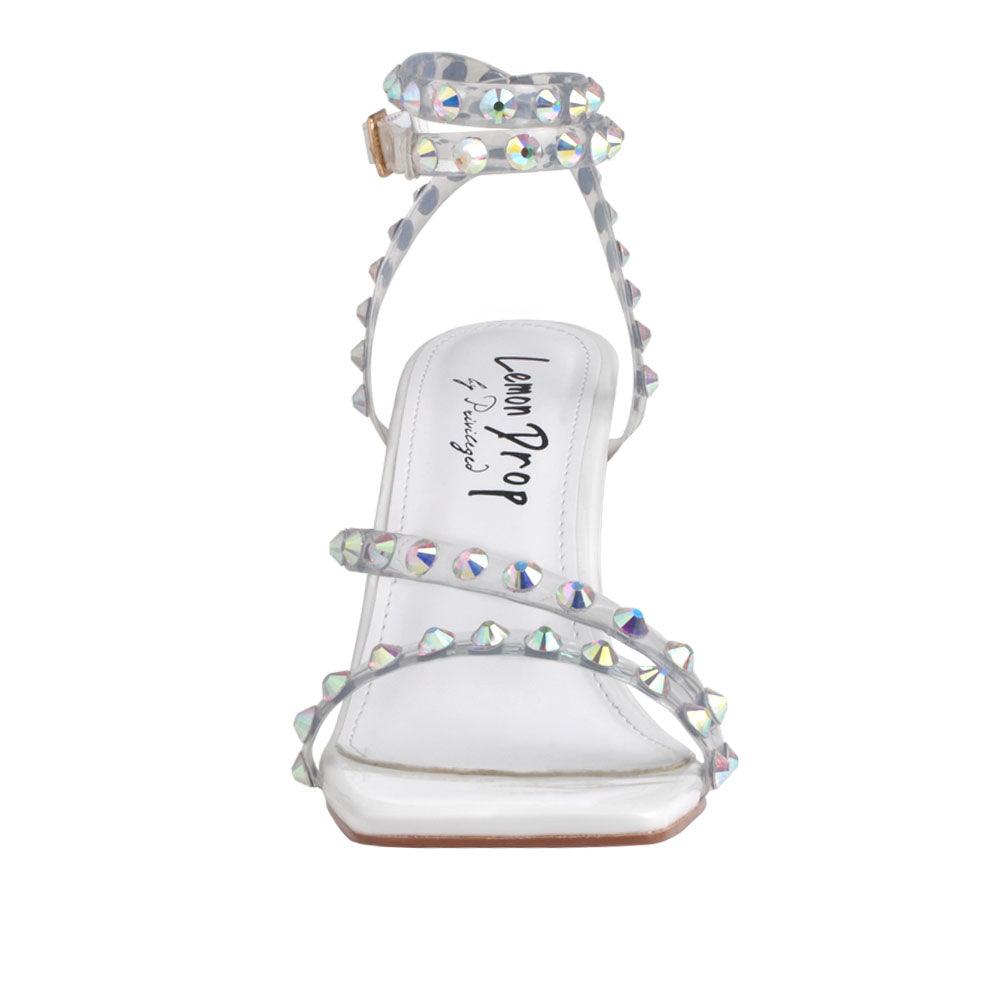 white colored heels with an open toe, beaded ankle straps, and buckle - front view