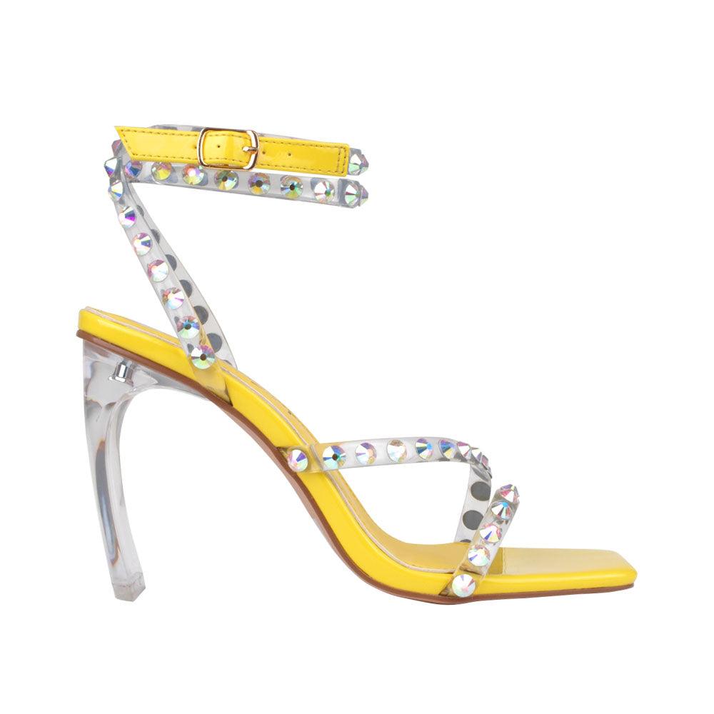 Ankle-strap heels in a bright yellow color with an open toe and buckle - side view