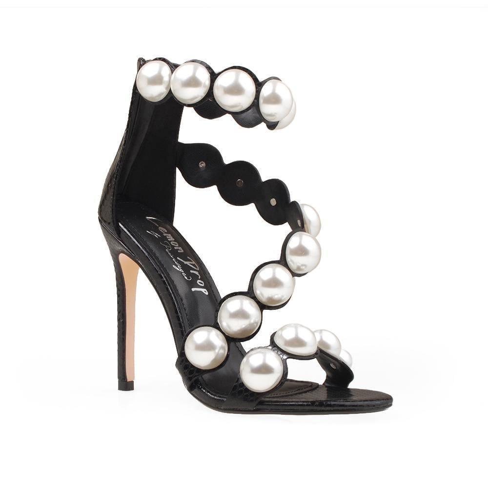 Women's heels in the color black with a silver pearl strap and a back zipper. - corner view