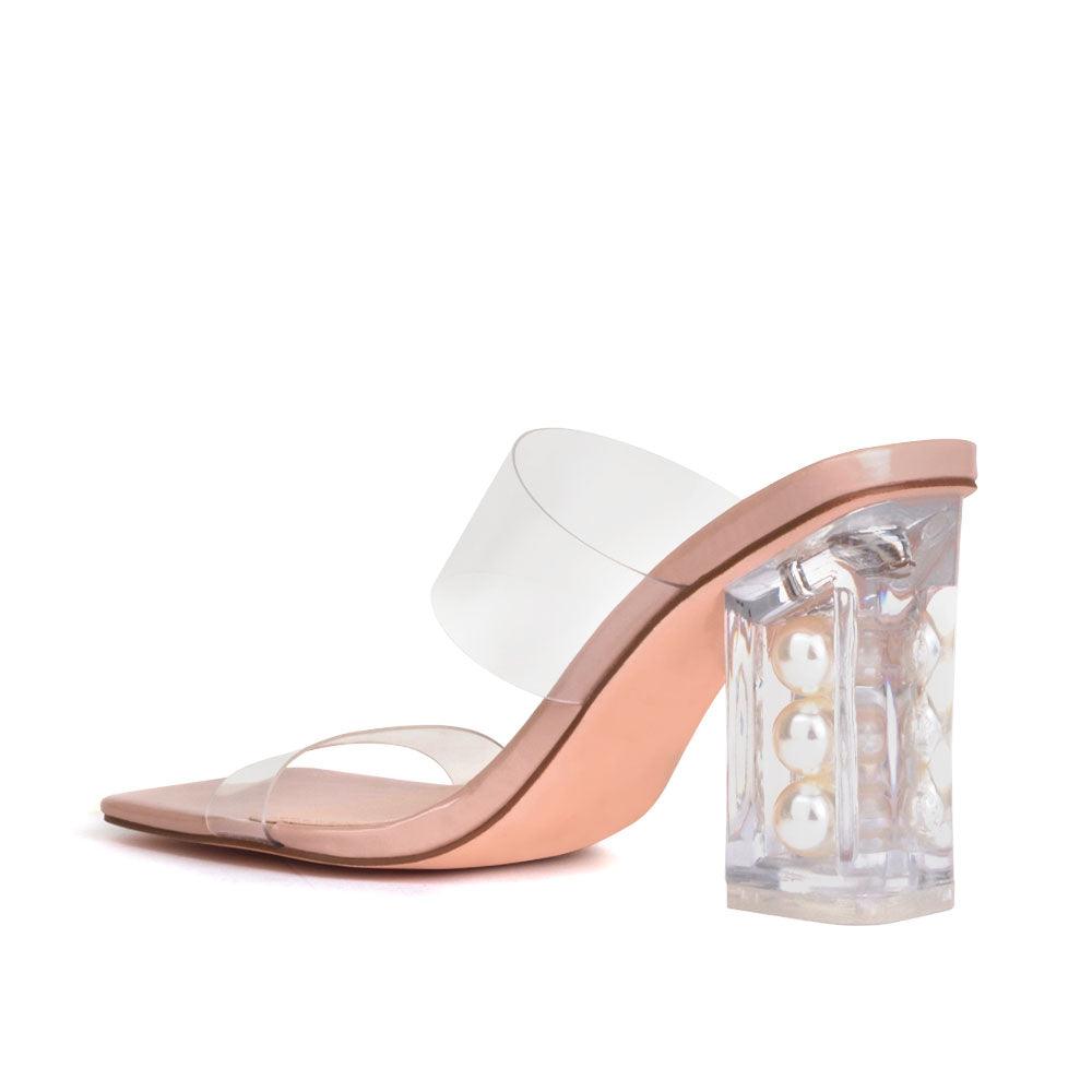 Nude-colored upper and block heels with a transparent strap-posterior view