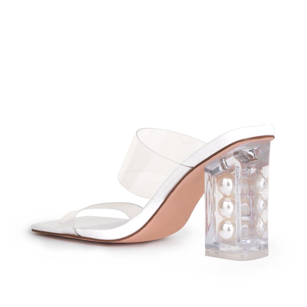 Clear block heels with a white upper and clear strap-posterior view