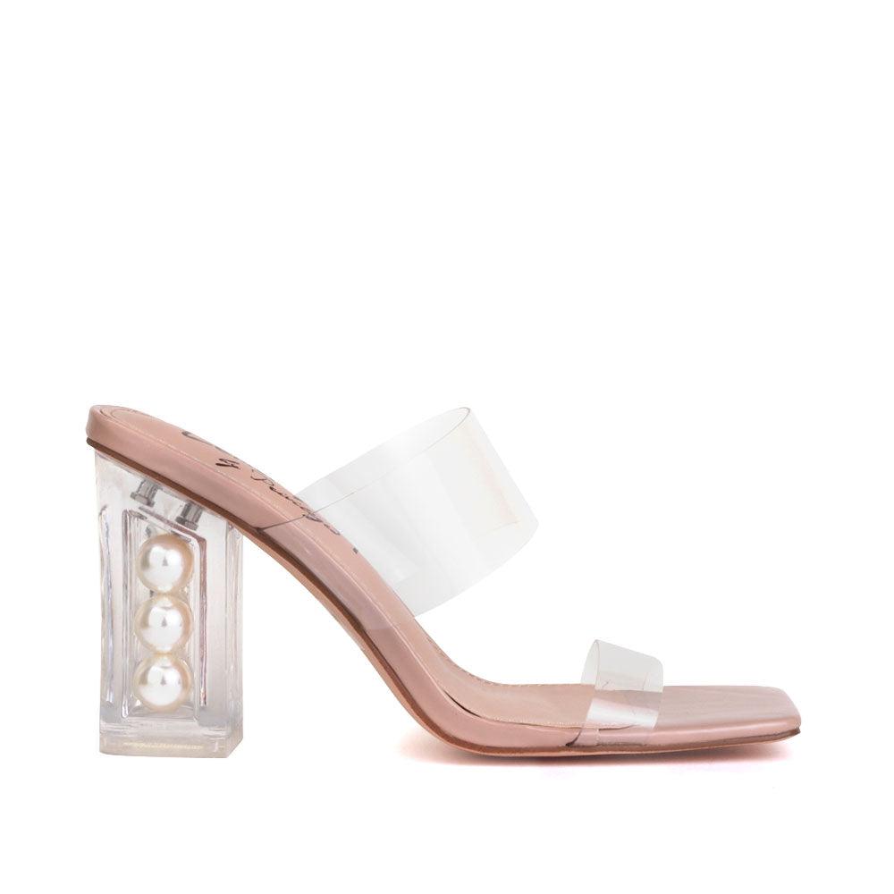 Nude-colored upper and block heels with a transparent strap-side view