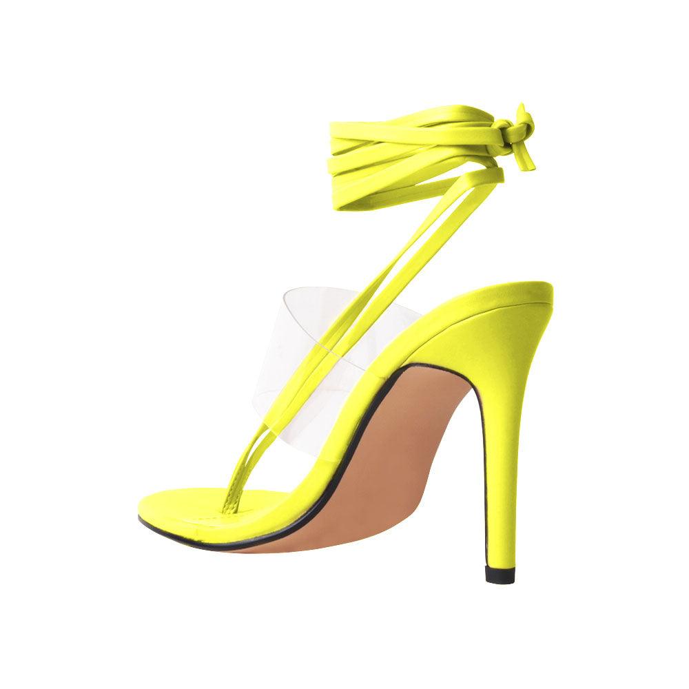 Women's yellow heels with lace tie up clasp and clear strap-posterior view