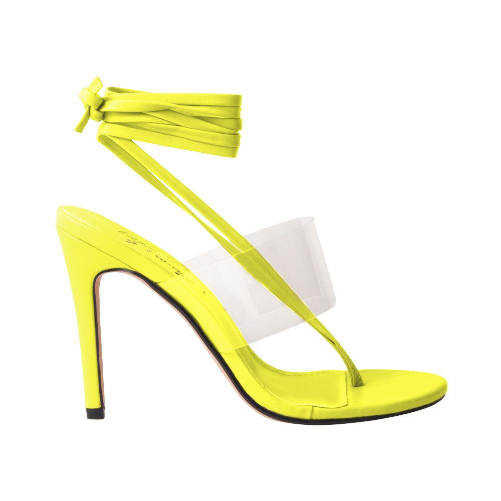 Women's yellow heels with lace tie up clasp and clear strap-side view