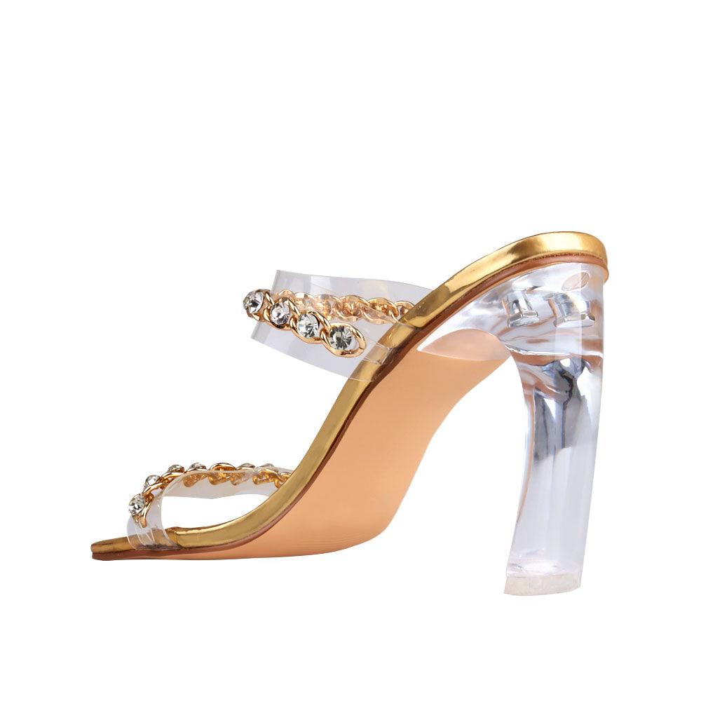 Golden-colored women's shoes with two-band vinyl crystal chain strap mule and transparent heels-posterior view