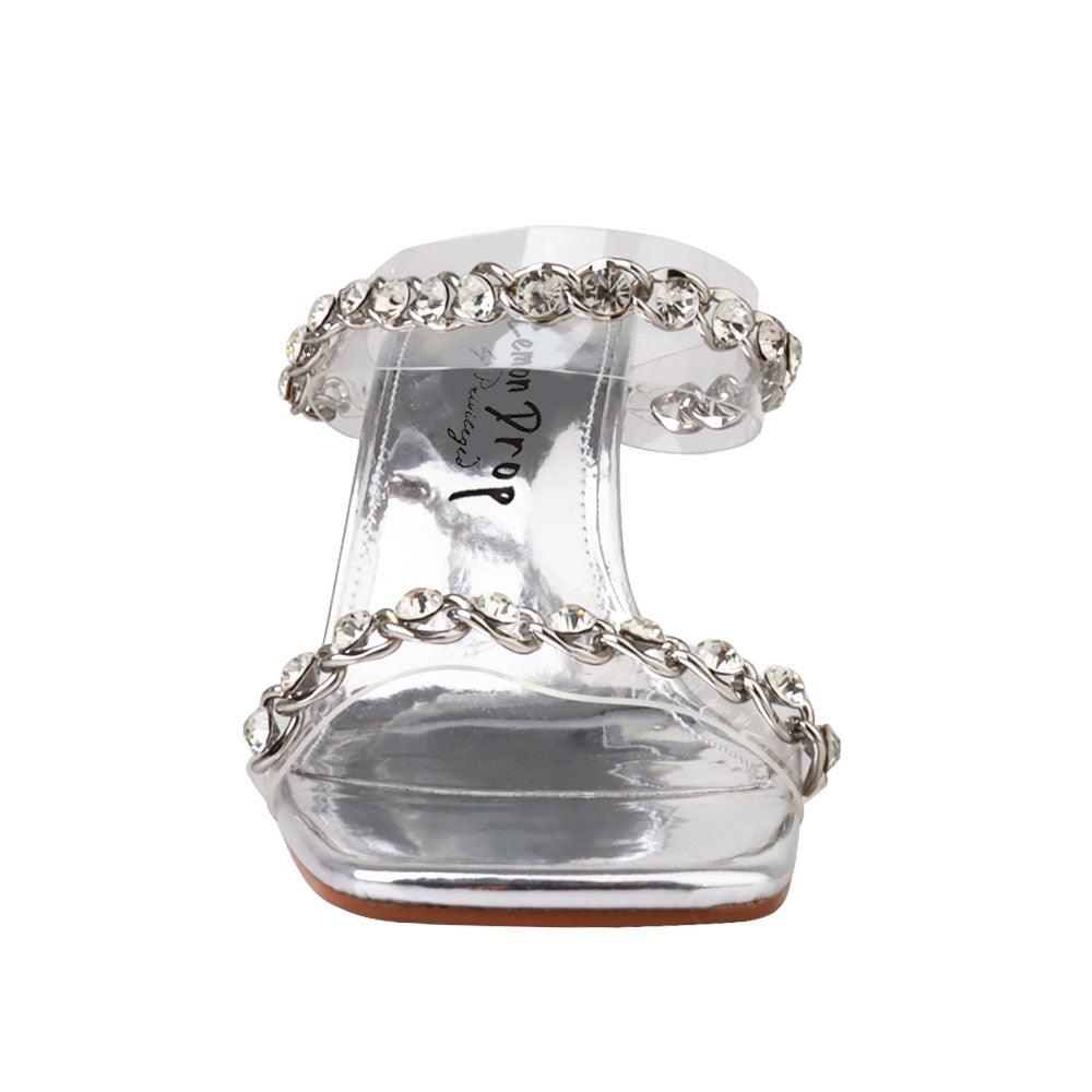 Women's silver shoes with a two-band vinyl crystal chain strap mule and transparent heels-front view