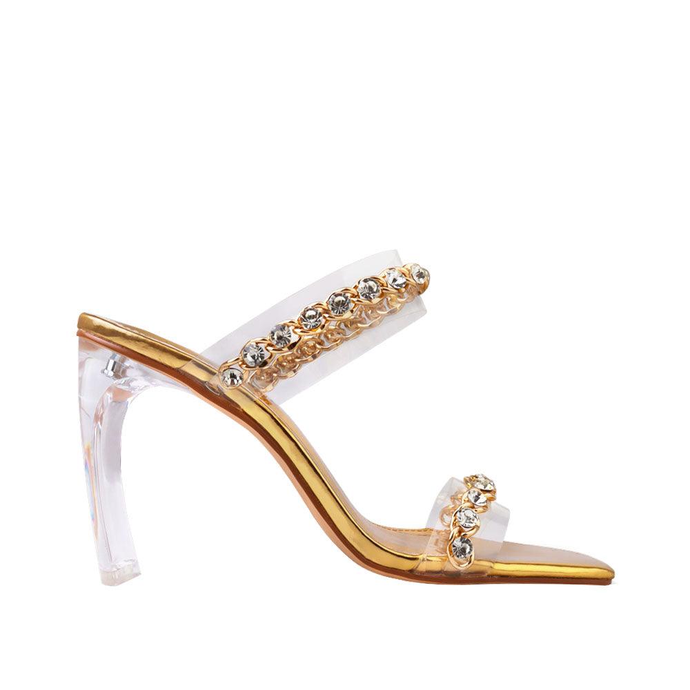 Golden-colored women's shoes with two-band vinyl crystal chain strap mule and transparent heels-side view