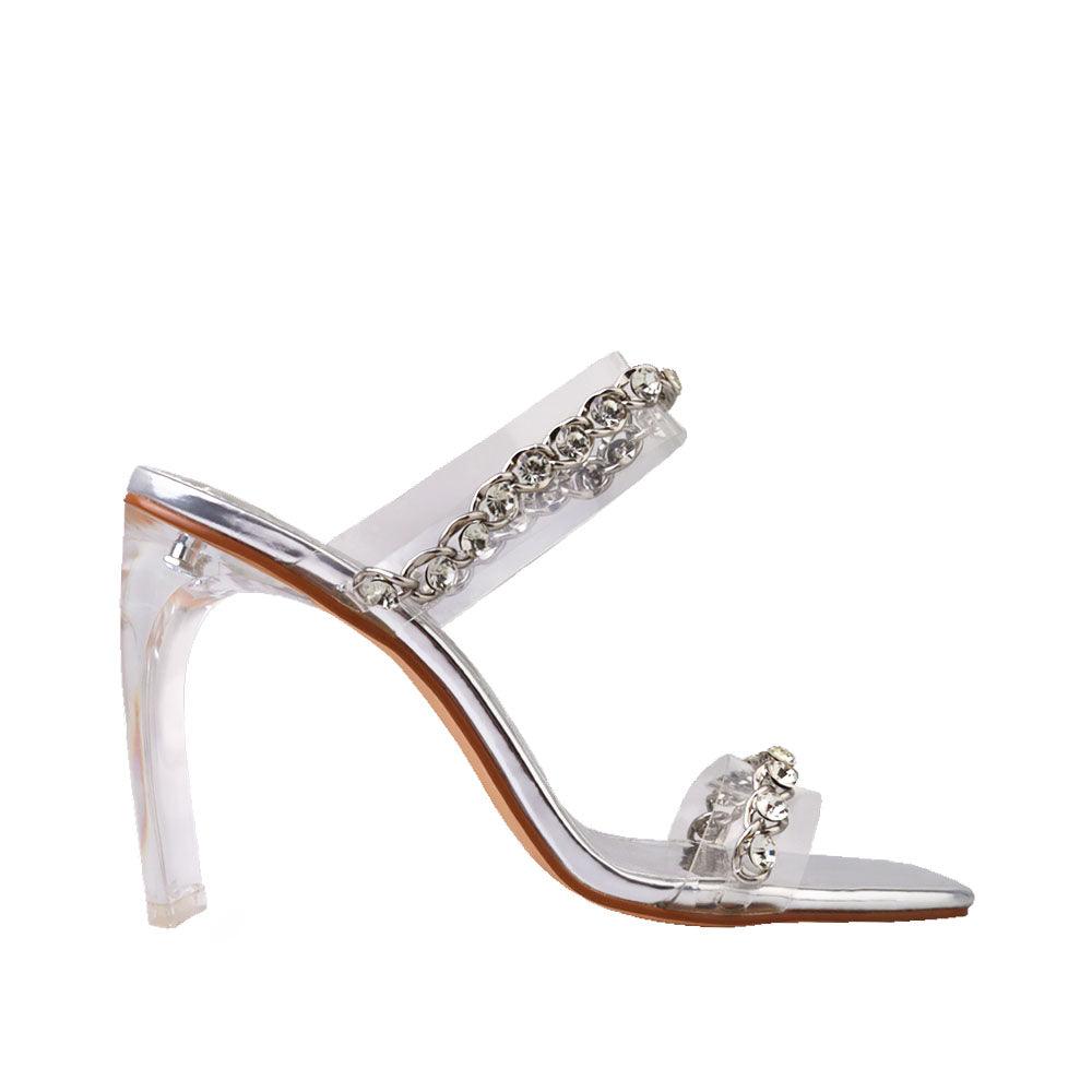 Women's silver shoes with a two-band vinyl crystal chain strap mule and transparent heels-side view