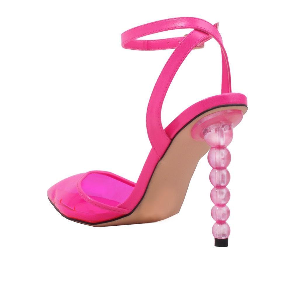 Fuchsia-colored shoes for women with a closed-toe semi-transparent vinyl top and ankle buckle fastening-posterior view