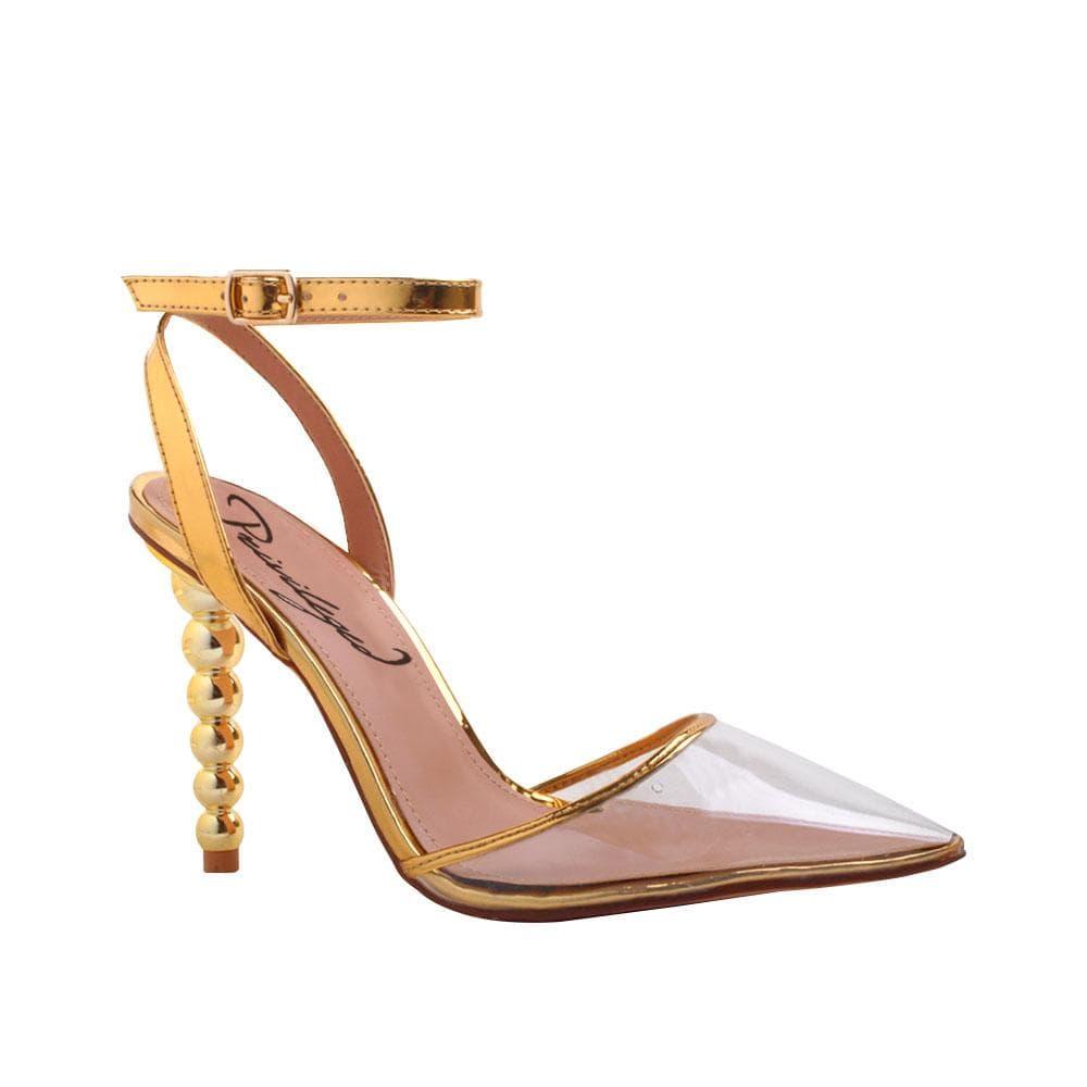 Women's golden-colored shoes with ankle buckle clasp and semi-transparent vinyl closed-toe top-corner view