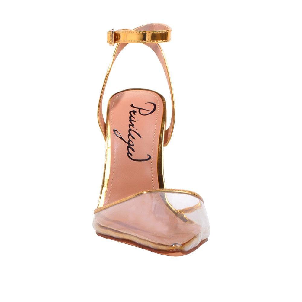 Women's golden-colored shoes with ankle buckle clasp and semi-transparent vinyl closed-toe top-front view