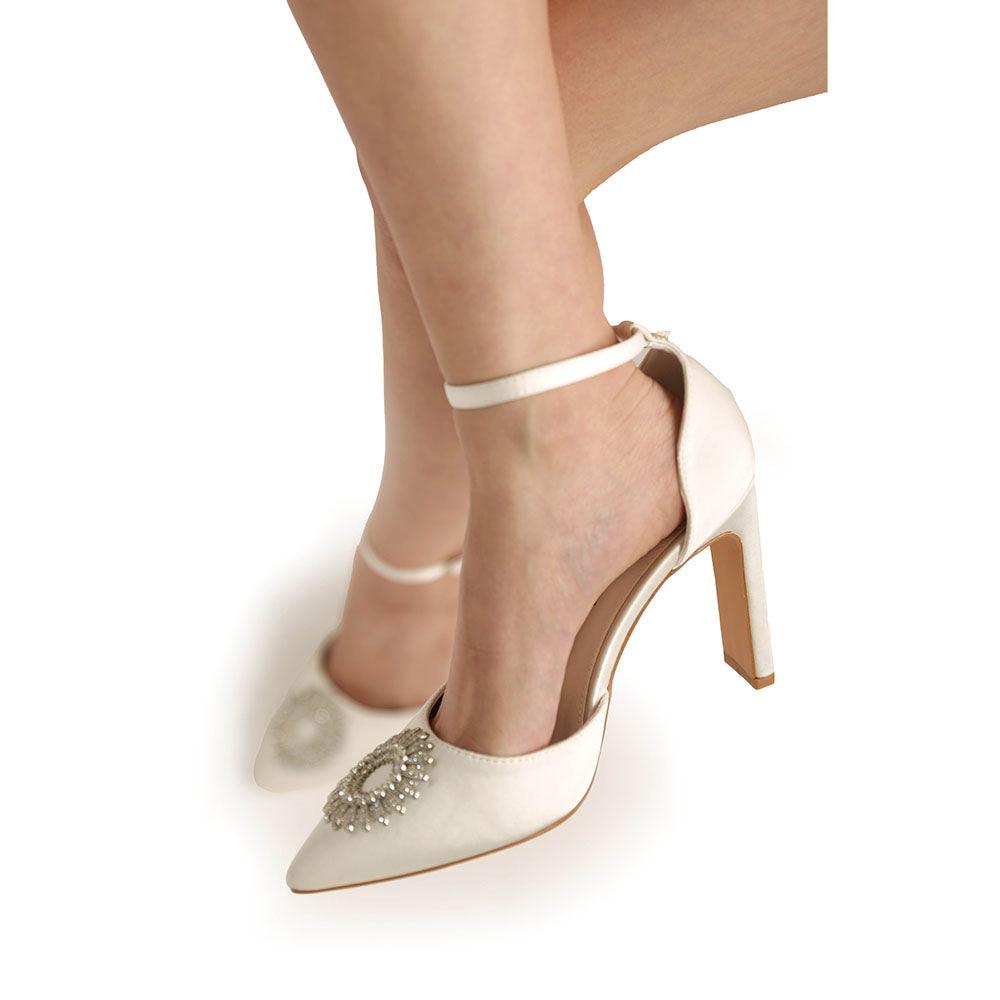 Women's white-colored heel with ankle buckle clasp and closed toe shinning silver design top