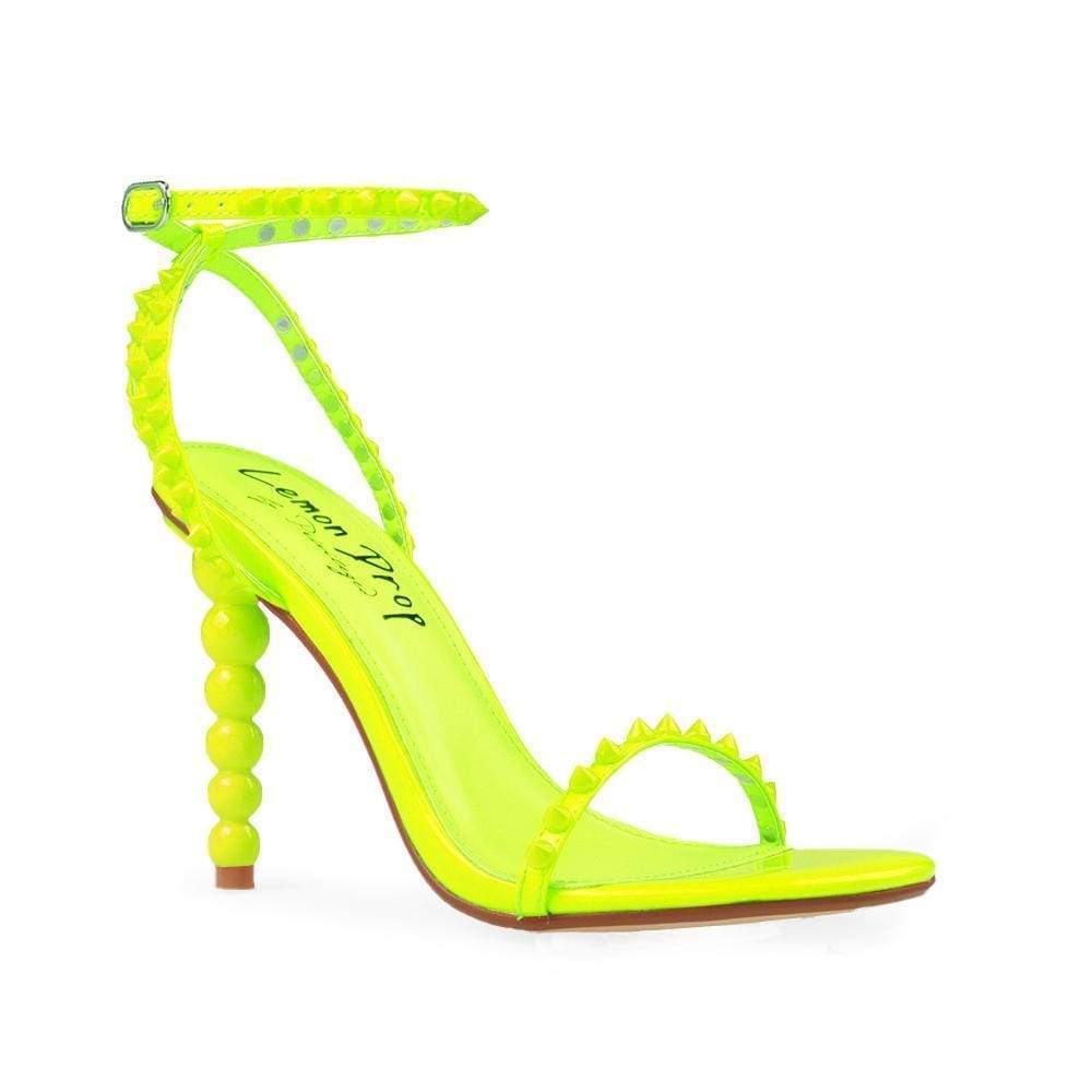 Women's neon yellow open-toed pearled shoes with a metallic studded ankle buckle clasp-corner view