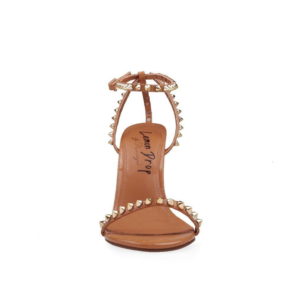 Tan-colored women's open-toed pearled heels with metallic studded ankle buckle closure -front view