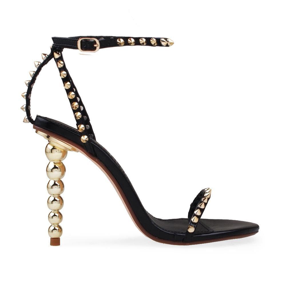 Women's open-toed pearled heels in black with a gold metallic studded ankle buckle fastening-side view