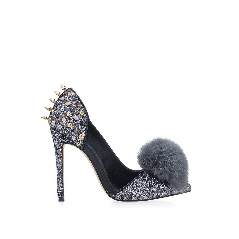 Women's pointed gray-colored fur pom heels with silver spike stud accents and slip on design-side view